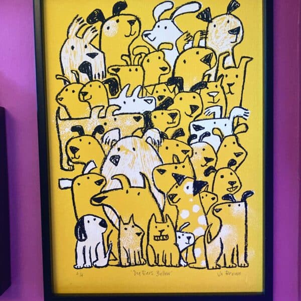 a framed screen print on yellow paper with black and white dog illustration