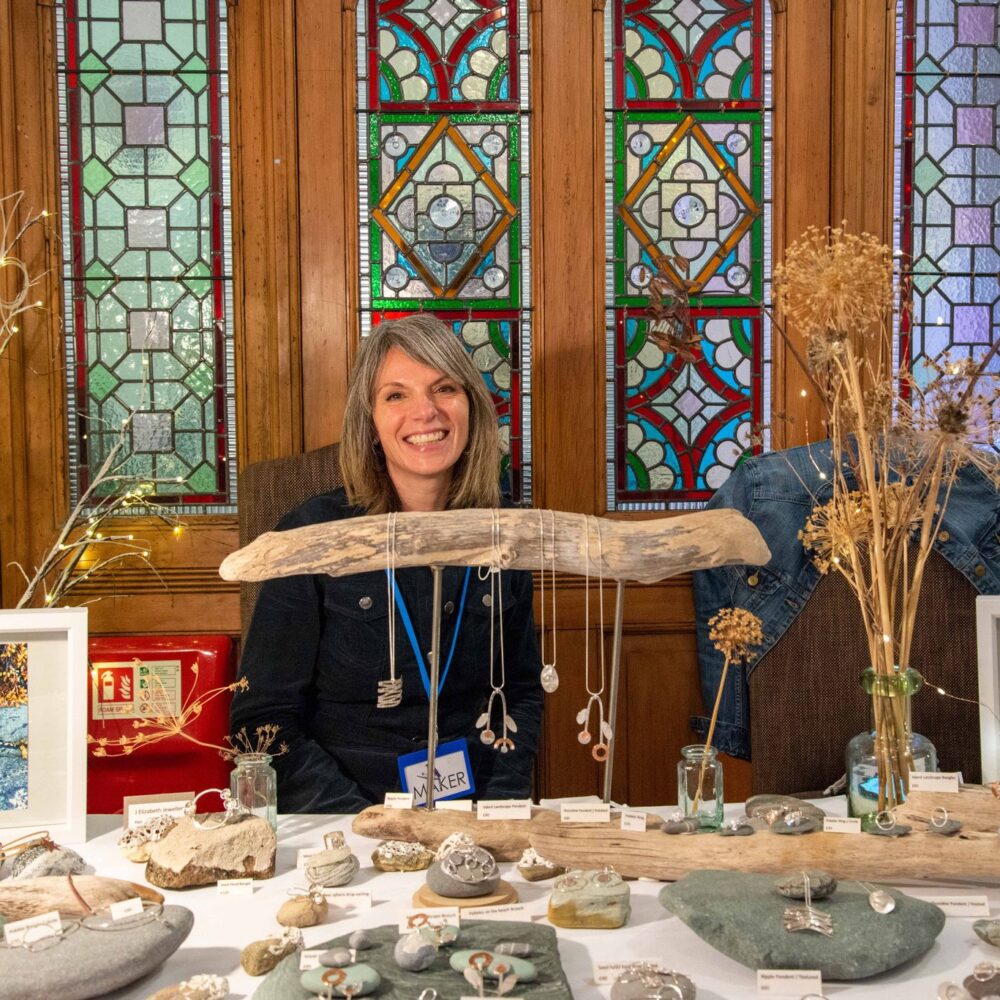 Stallholder standing inside Elmslie House - Blue Magpie Contemporary Craft Fair