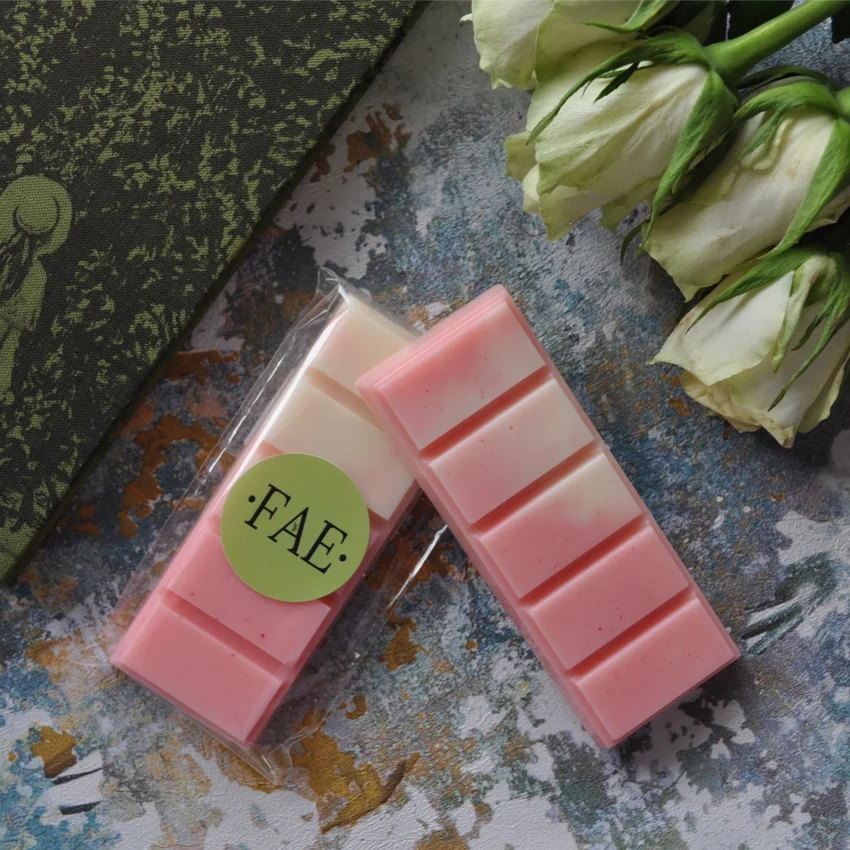 A wax melt in the scent The Secret Garden with a book and white roses in the background.