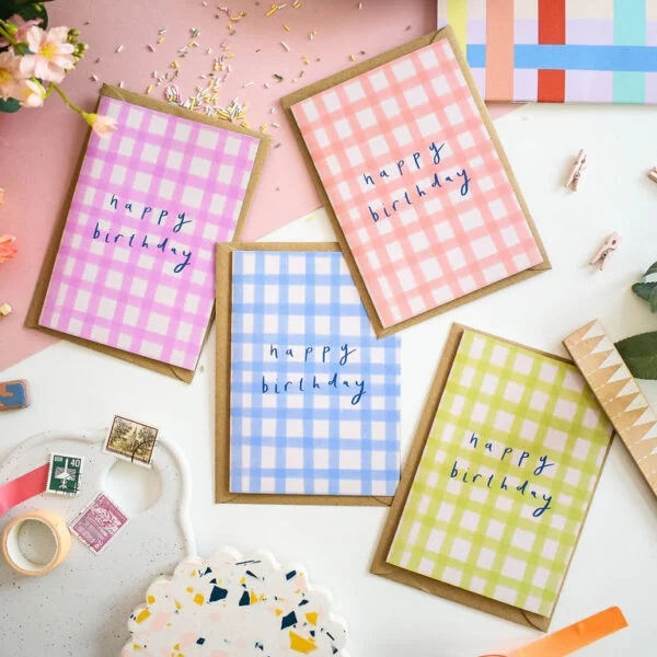 Pack of 4 birthday cards with the text happy birthday on them in different colours