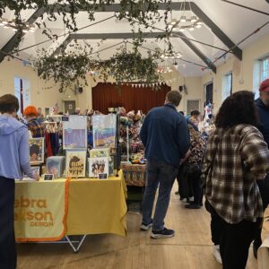 A community hall filled with makers’ stalls