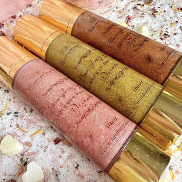 A gold, a pink and a bronze shimmer body oils