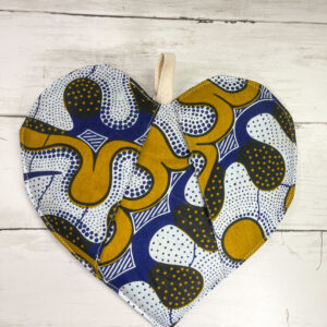 An African-inspired heart-shaped pot holder featuring vibrant colors and intricate patterns, ideal for adding a touch of culture and style to your kitchen decor. The pot holder is crafted with meticulous attention to detail, showcasing traditional African design elements and providing both functionality and aesthetic appeal.