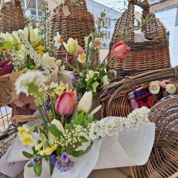 Stall with a range of handmade baskets and spring homegrown flowers