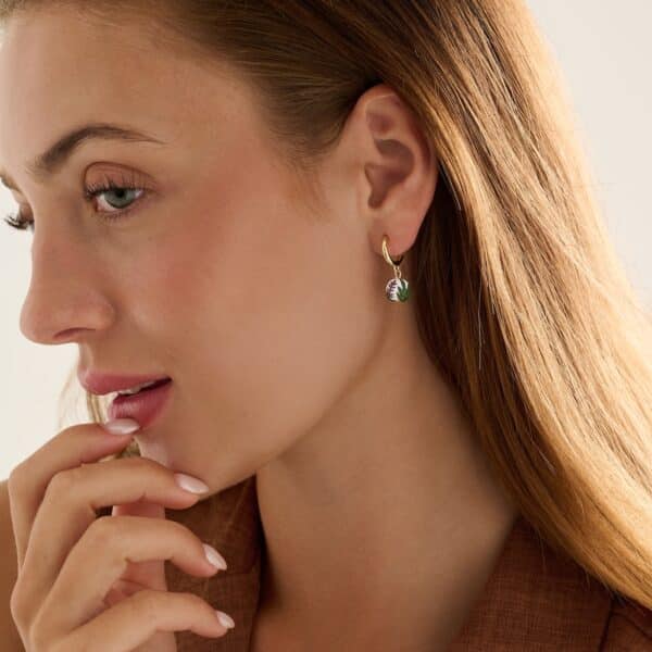 female model wearing a pair of small dainty round earrings with lavender design