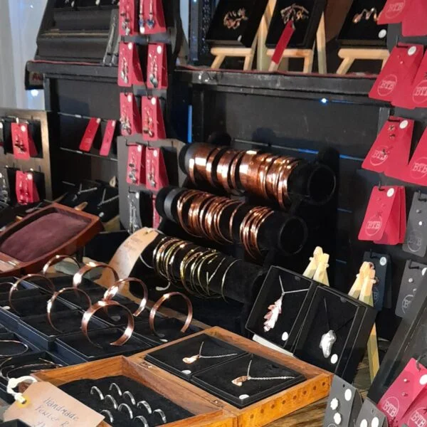 Copper banges and earrings displayed on a stall at a recent market