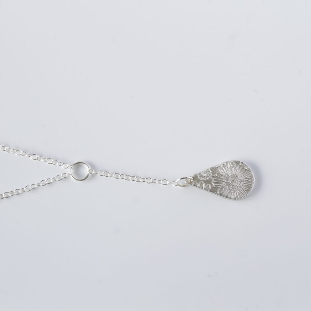Abby's Art Atelier- Floral Embossed Fine Silver Teardrop Necklace. On a sterling Silver Chain