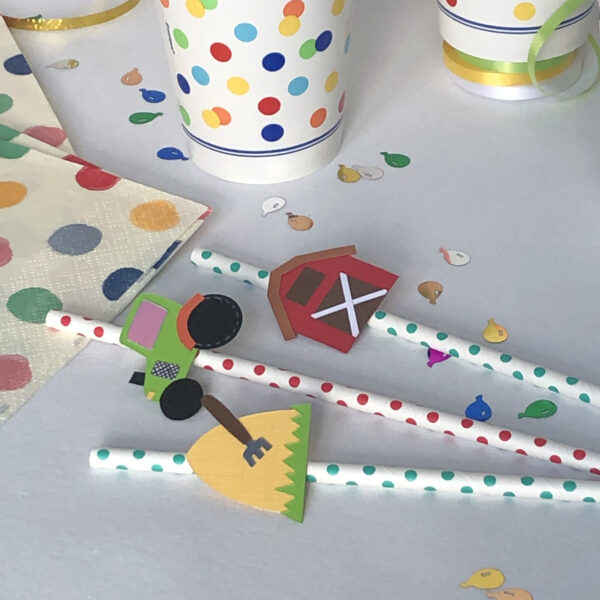Set of farm theme paper drinking straws decorated with hay bale, barn and tractor.