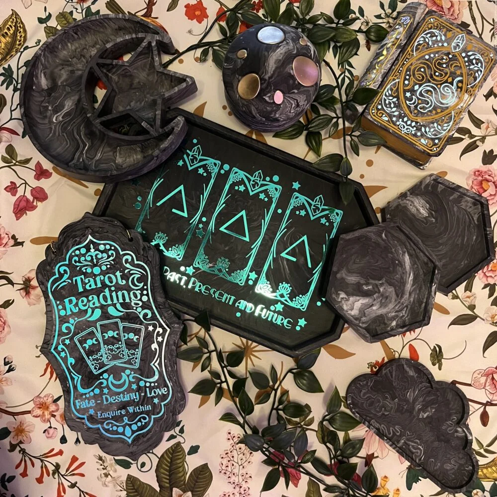 A photo containing dark grey coasters, a moon & star shaped tray, a cloud tray, a mushroom jar and 2 book shaped jewellery boxes