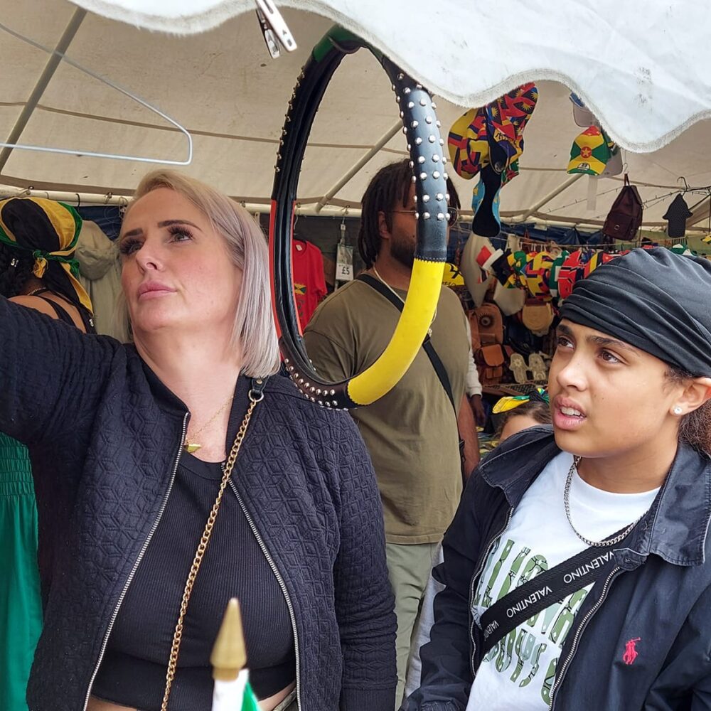 Trodition Market customers (mother and son) browsing crafts accessories stall