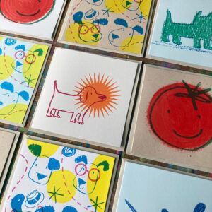lots of printed cards with fun illustrations laid in a grid pattern