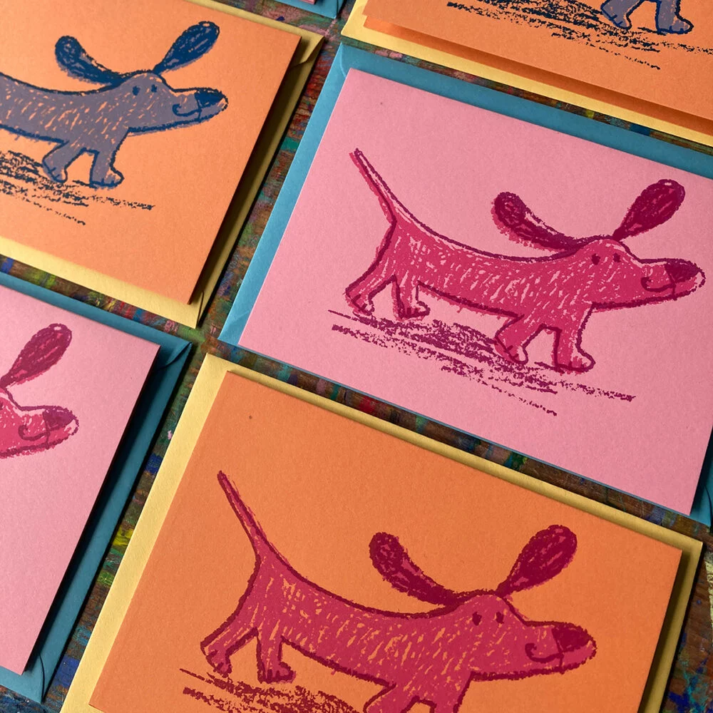 colourful cards printed with sausage dog illustration by Jo Brown