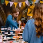 Mindful Market at Leeds Corn Exchange - stallholder chatting to a customer