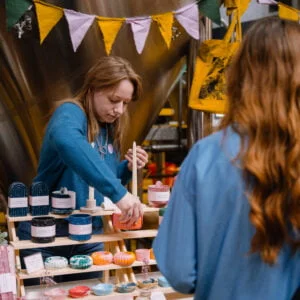 Mindful Market at Leeds Corn Exchange - stallholder chatting to a customer