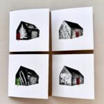 This greeting card set features a collection of four unique designs, each portraying a stylised barn with a nature-inspired theme. Each card is printed on high-quality FSC-certified paper, ensuring that it is sourced from responsibly managed forests. The designs include the following elements: 1. Top Left Card: This card features a barn silhouette with a prominent white fern motif against a black background, with a striking red door that adds a pop of colour. 2. Top Right Card: The barn design is embellished with a delicate plant pattern, accompanied by a bright pink door that contrasts with the monochrome background. 3. Bottom Left Card: A black barn image is decorated with a series of white fern fronds leaves, highlighted by a vibrant green door for a touch of colour. 4. Bottom Right Card: This card shows a barn adorned with a subtle, leafy pattern in white, set against a textured grey backdrop, and includes a vivid red door for visual interest. These cards are perfect for nature lovers and those who appreciate minimalist, rustic art. The FSC-certified paper ensures that these greeting cards are environmentally friendly, aligning with sustainable practices and to make hem extra special, the barn doors on each card open!