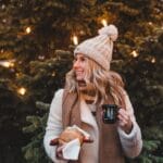 Leeds Bond Court Christmas Artisan Market - lady with a hot drink in front of a christmas tree