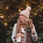 Leeds Bond Court Christmas Artisan Market - lady with a hot drink in front of a christmas tree
