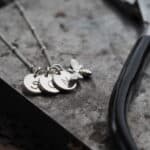 3 silver initial discs on a silver chain necklace