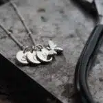 3 silver initial discs on a silver chain necklace