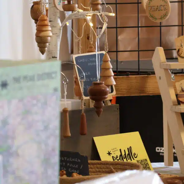 A contemporary wood turning stall at Tissington Craft Fair in Derbyshire with Peak District jigsaw puzzles in the foreground, Tissington Craft Fairs