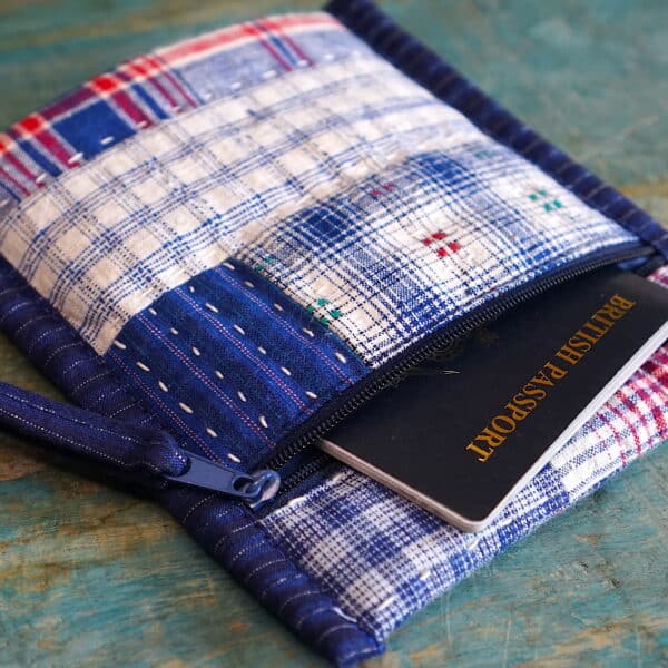 Patchwork fabric pouch holding a passport