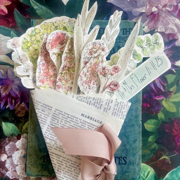 Painted watercolour flower stems hand cut and arranged into a bouquet wrapped in book pages