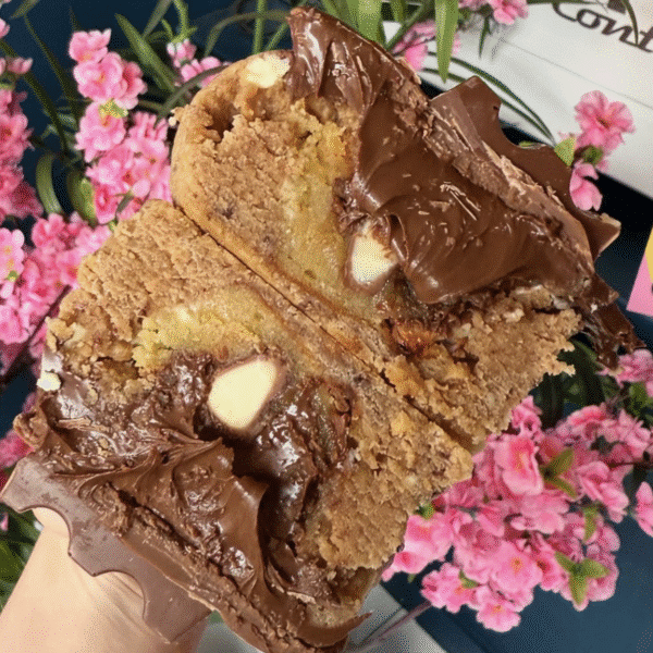 A giant stuffed cookie cut in half with oozing chocolate at the next Wylde Thistle artisan market