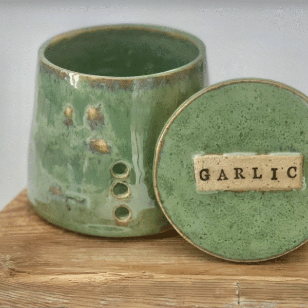 A beautiful ceramic pistachio green glazed garlic pot available at the next Wylde Thistle market