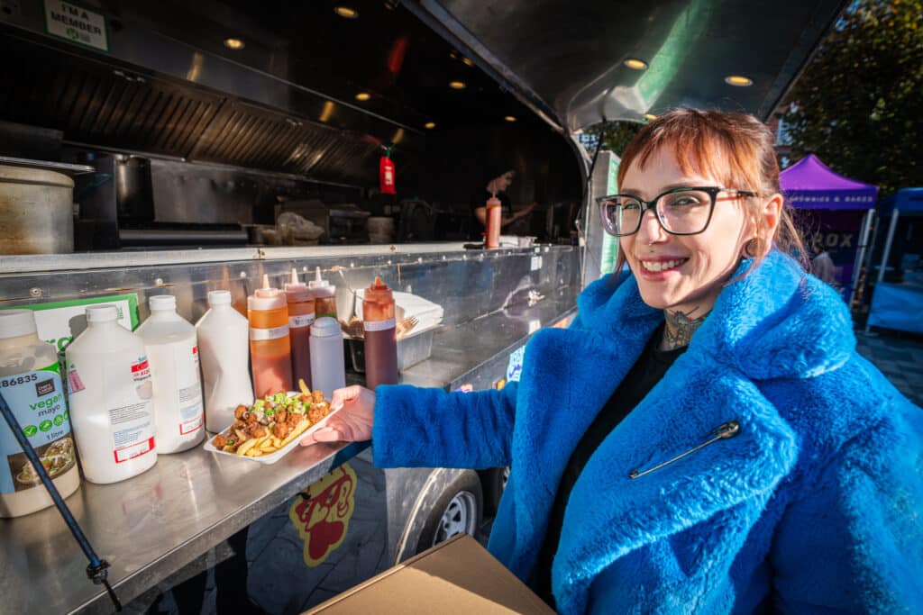Customer enjoying No Frickin Chicken at Vegan Market by Vegan Fairs