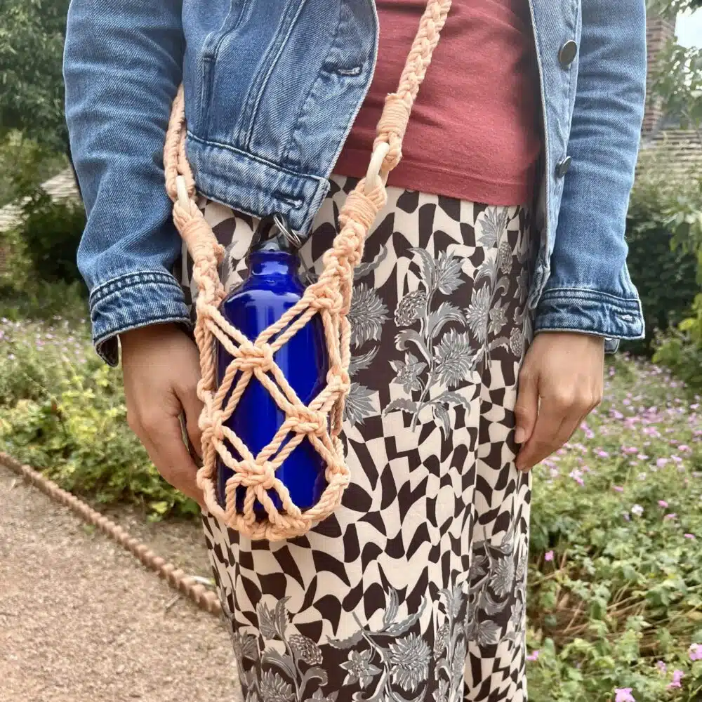 Sophie's Spirals, peach coloured macrame water bottle carrier.