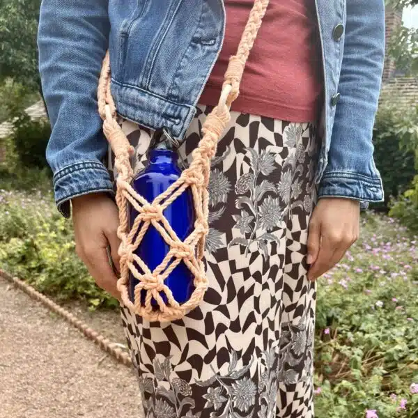Sophie's Spirals, peach coloured macrame water bottle carrier.