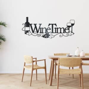 Black metal wall art featuring the words “Wine Time” with a wine bottle replacing the letter “I,” two wine glasses, grapevine accents, and grape clusters, displayed above a light wood dining table in a bright, modern dining room or kitchen.