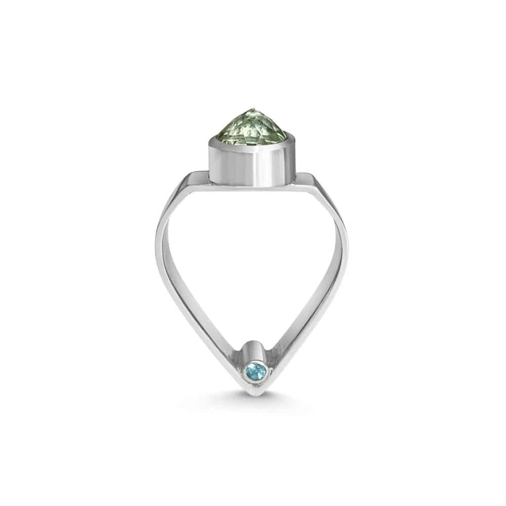 A ring with an arch shaped shank topped with a pointed green prasiolite and featuring hidden blue topaz gems