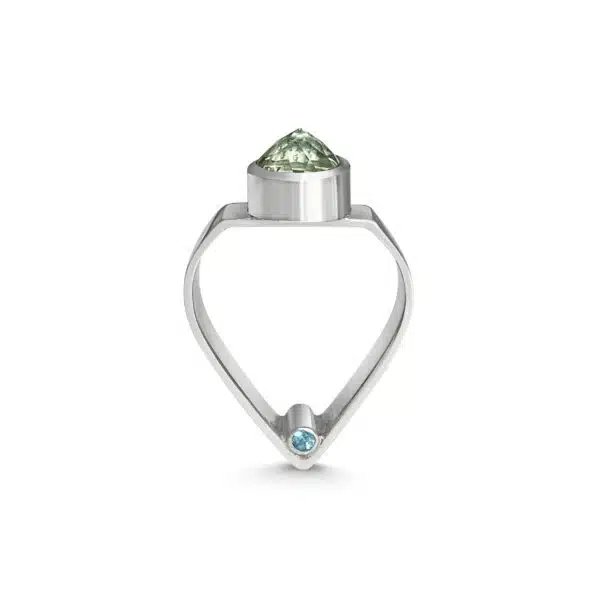 A ring with an arch shaped shank topped with a pointed green prasiolite and featuring hidden blue topaz gems