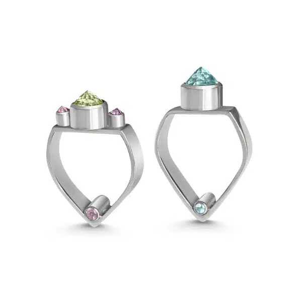 A pair of ARCH rings from Odeda Jewelery. Both feature arch shaped shanks. The ring on the left features prasiolite flanked by two pointed amethysts and the silver ring on the right features a pointed central topaz and two hidden topaz at the bottom of the ring.