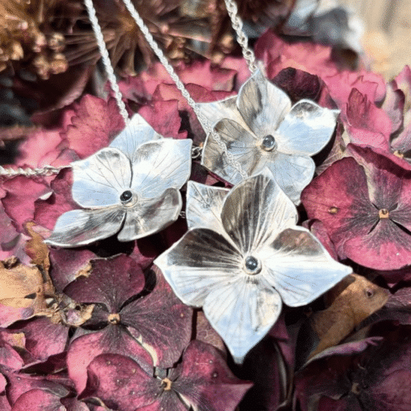 Three silver necklaces with a silver hydrangea flower shaped pendant