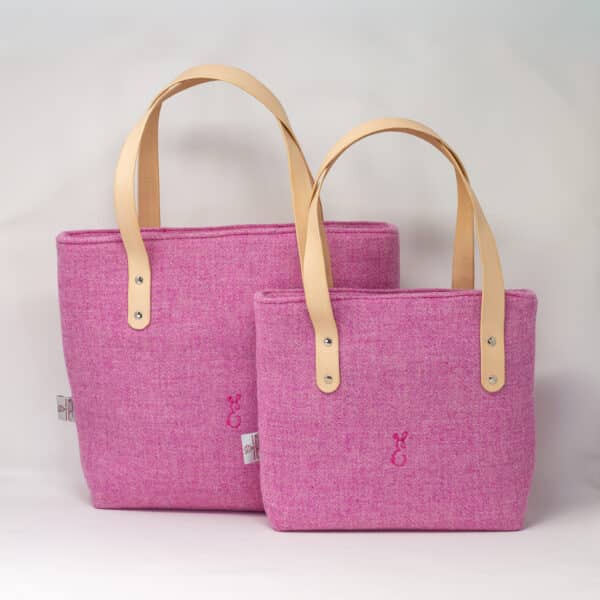 Two pink Harris Tweed® cloth tote bags with natural leather handles, handcrafted in Wales by Emma Easter Handcrafted.