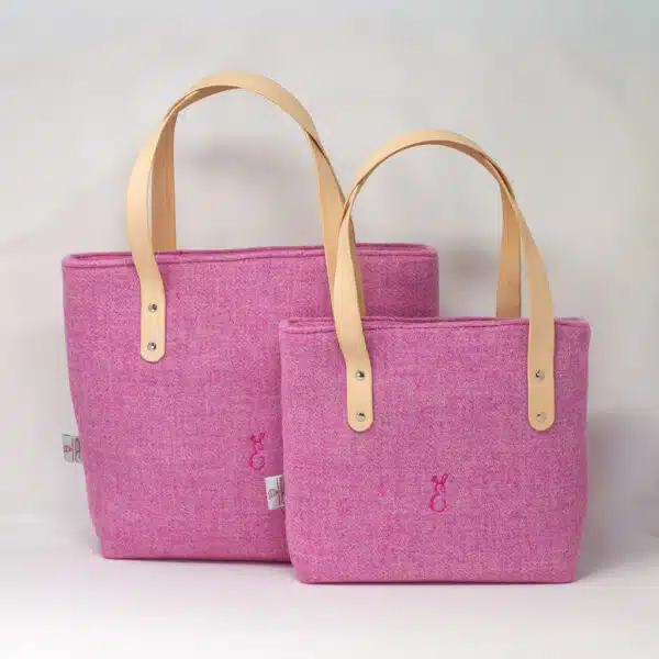 Two pink Harris Tweed® cloth tote bags with natural leather handles, handcrafted in Wales by Emma Easter Handcrafted.