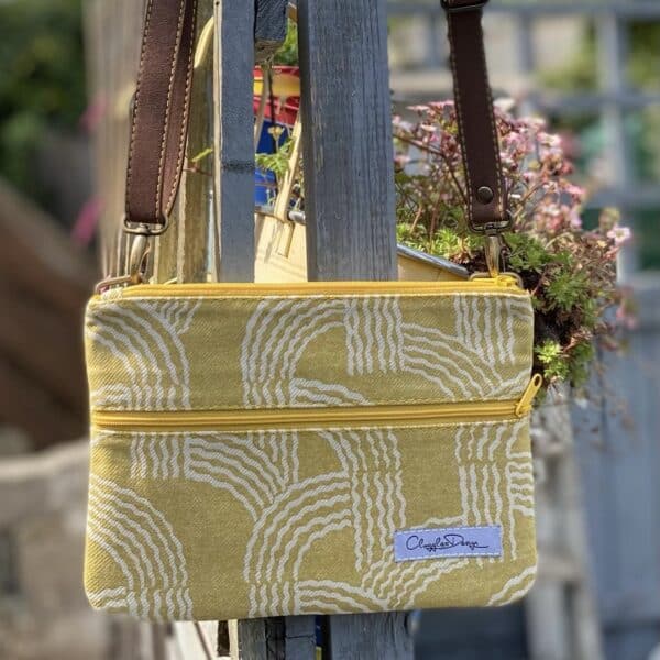 ClogglesDesign Crossbody/Travel Bag made from end of line fabric. Yellow with white Arch Pattern. 16cm x 22cm with a front zip pocket, slip-in back pocket, credit card pockets and detachable faux suede leather strap.