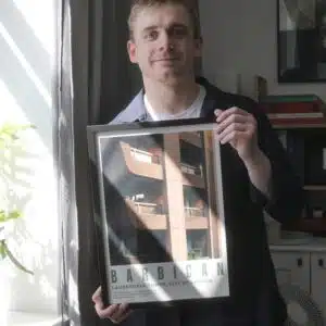 Joshua holding a Framed Print of the Barbican - Joshua Prints