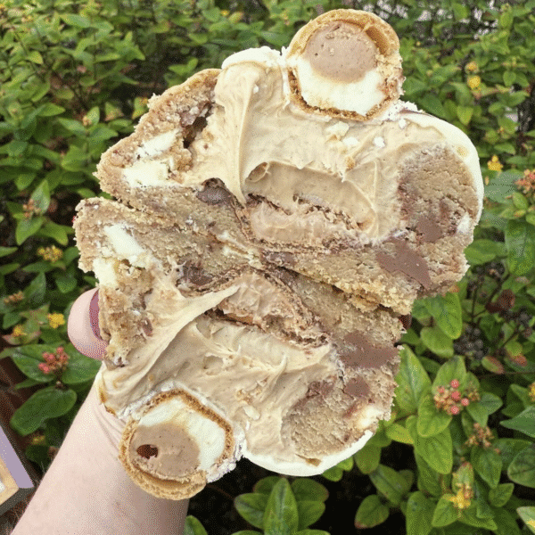 A large cookies cut in half and filled with chocolate and flavoured cream