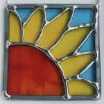 A yellow part sunflower in stained glass with turquoise background, by Tad Glass.