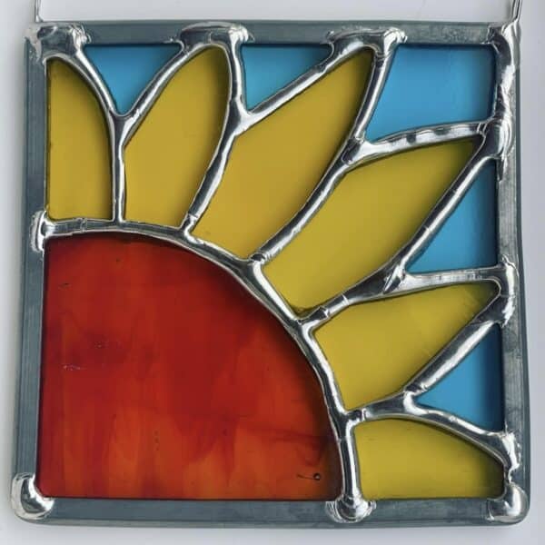 A yellow part sunflower in stained glass with turquoise background, by Tad Glass.