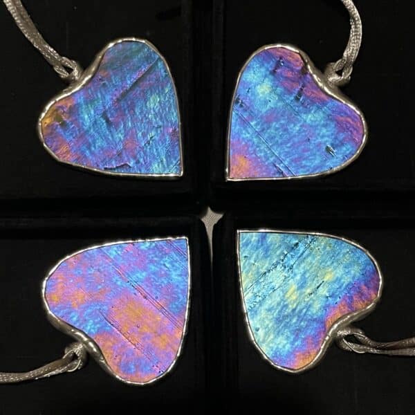 4 iridescent stained glass hearts in a circle with a contrasting dark background, by Tad Glass