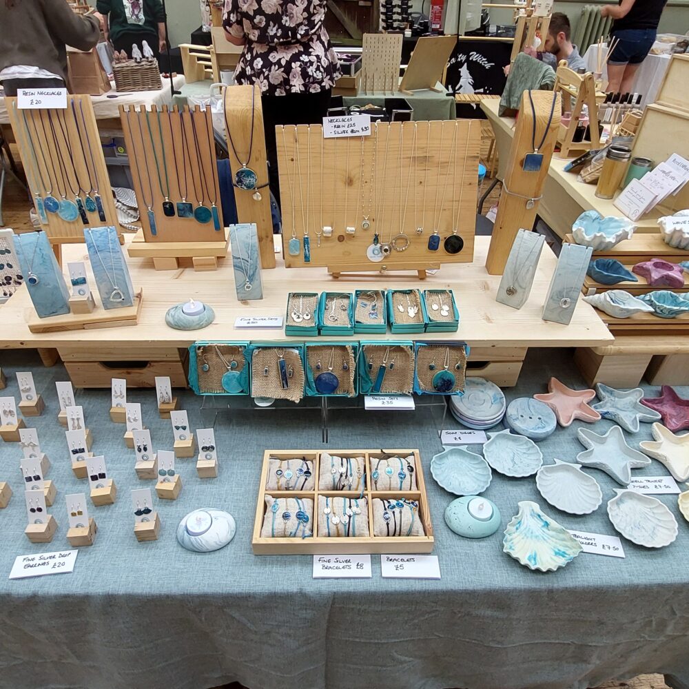 Image depicting a craft fair layout with jewellery, tealight holders and trinket dishes all handmade by aquaticfreckle