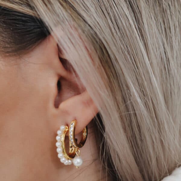 Model with two pearl hoop earrings
