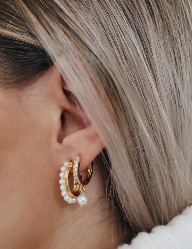 Model with two pearl hoop earrings
