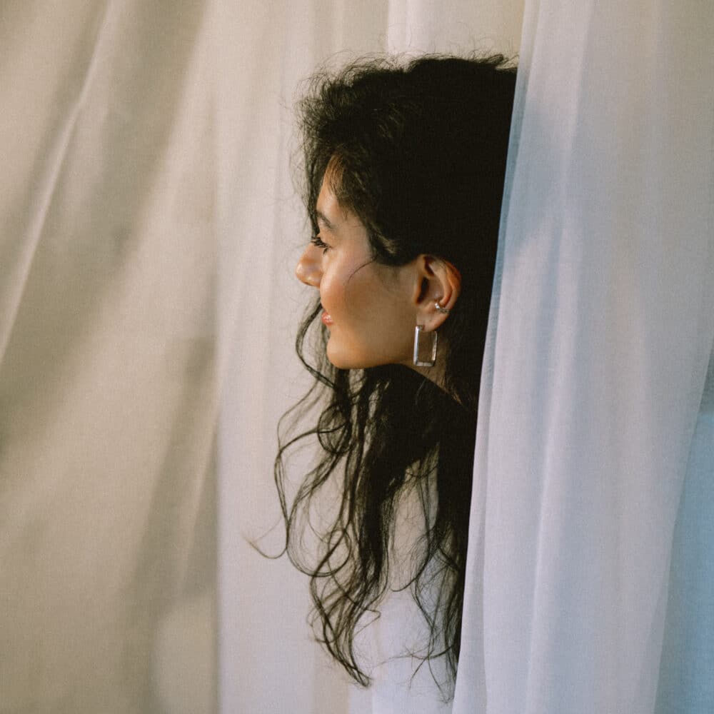 Long black hair with silver jewellery silver hoops