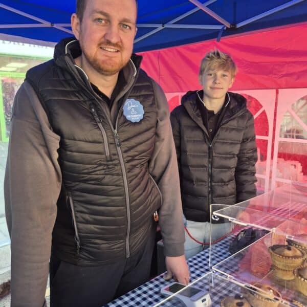 Vendors smiling at an outdoor market