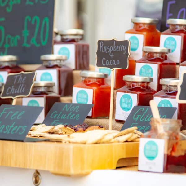 A market stall with a display of jams and preserves